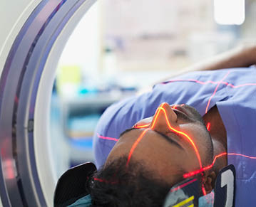 Mid adult male patient going through CAT scan