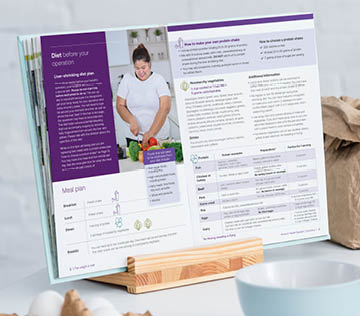 blank opened cookbook on table with cooking utensils and bakery ingredients