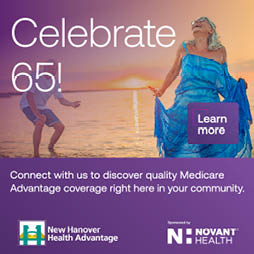 A woman in a blue dress is shown on a beach, smiling and holding her arms out. The image is advertising Medicare Advantage coverage. AI generated content