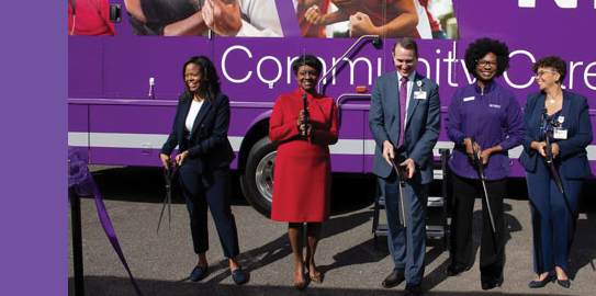 A group of people are standing in front of a bus, posing for a picture. AI generated content