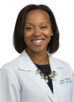 A woman in a white coat and a necklace smiles for the camera. AI generated content