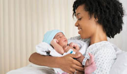 A woman holding a baby in a hospital bed. AI generated content