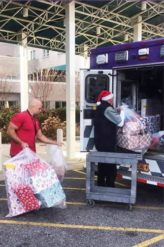 A man is loading gifts into a medical truck. AI generated content