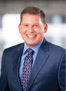 A man wearing a suit and tie is smiling for the camera. AI generated content